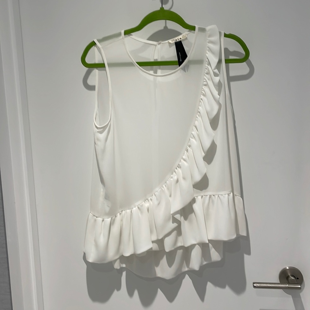 Show off  your tan with this super fem tank! Ruffle details around hem & front.